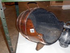 A copper bound oak log barrel with label 'Made from the battleships of Britain Winston Churchill'