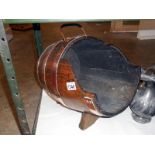 A copper bound oak log barrel with label 'Made from the battleships of Britain Winston Churchill'