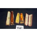 A cased cheroot holder with 9ct rose gold collar, an amber mouthpiece,