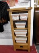 A rustic solid oak shelf unit with fabric baskets