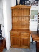 A waxed pine dresser with 2 drawer 2 cupboard base