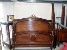 A French wooden double bed with ormalu gilded brass fittings
