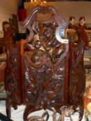 Carved oak fire screen