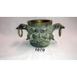 A heavy 20th century bronze pot with 2 handles & face masks either side.