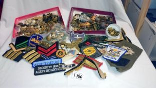 A quantity of Military items including buttons & cloth badges etc.