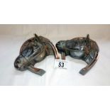 A pair of metal horse head ink wells - a/f (hinges off both)