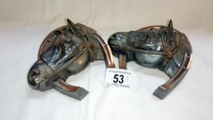 A pair of metal horse head ink wells - a/f (hinges off both)