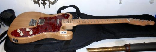 A custom solid electric guitar and Fender soft case
