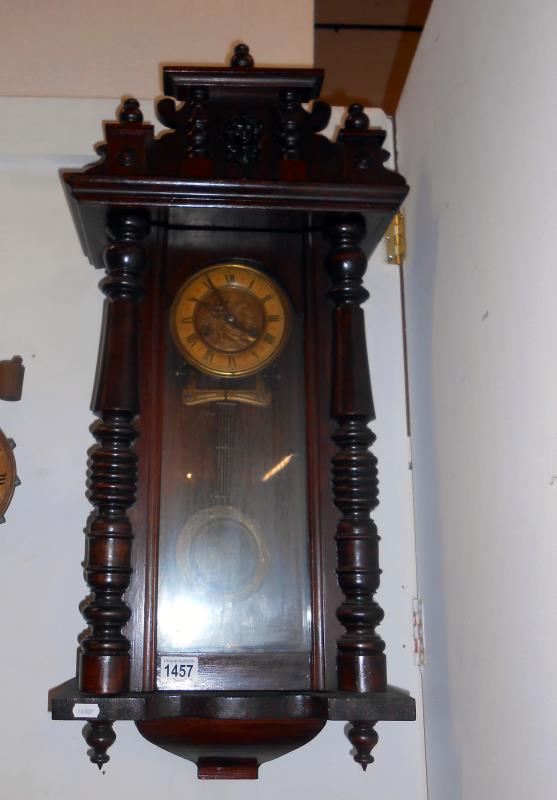 A wall clock with key and pendulum