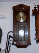 A wall clock with key and pendulum