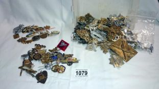 A quantity of Military items including badges & sweetheart brooches etc.