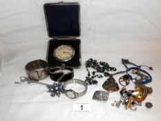Quantity of costume jewellery and a travelling clock