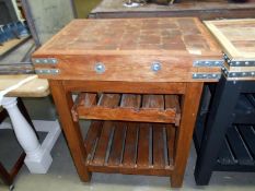 A butchers block on stand with wine rack