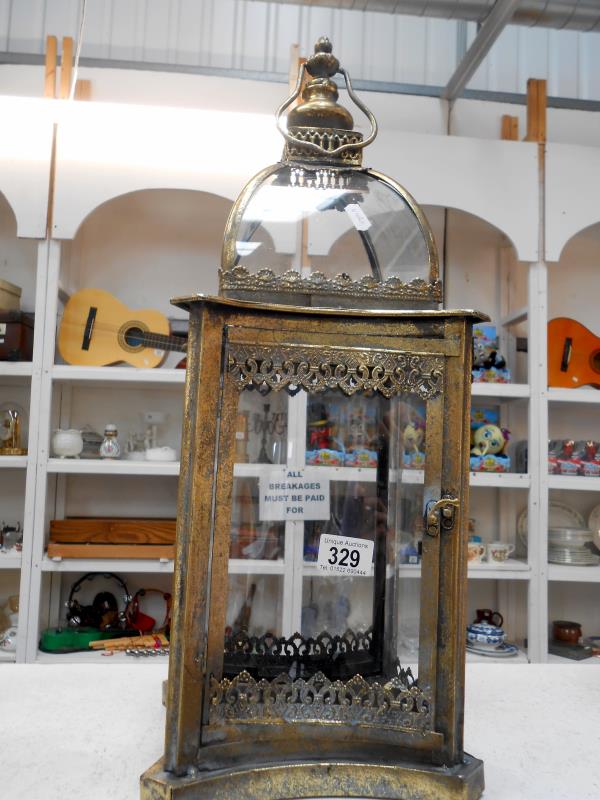 A metal and glass garden lantern