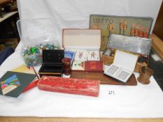 A small suitcase containing games including marbles,