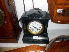A slate mantel clock with key and pendulum
