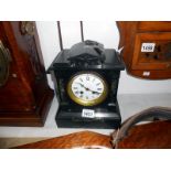 A slate mantel clock with key and pendulum