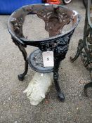 A stone pig & a Victorian cast iron table (missing top)