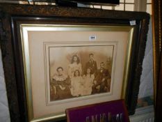 A large ornate framed Edwardian family group photograph