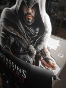 A quantity of 'Assassins Creed' promotional cutouts etc.