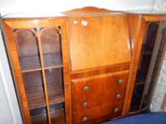 A 3 drawer bureau with display cabinets each side