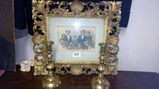 A Victorian gilt photo frame & pair of Victorian candlesticks