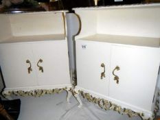 A pair of white painted bedside cabinets with ormalu decoration