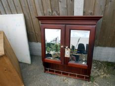 A mirrored 2 door shelf unit