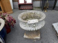 A stone planter on stand