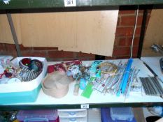 A shelf of craft items, needles etc