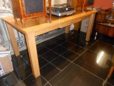 A large pine table with drawer