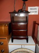 A mahogany bed side table