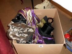 A box containing top hats & clths etc.