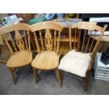 A pair of kitchen chairs and a stick back chair