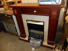 A coal effect electric fire with surround