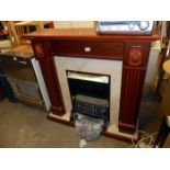 A coal effect electric fire with surround