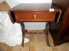 A small mahogany table with drawers