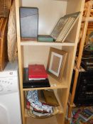 3 shelves of place mats, photo frames etc