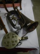 A copper and brass bugle with maker's mark and an unusual powder flask