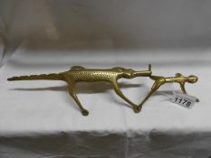 An early primitive brass Chinese man being chased by an alligator