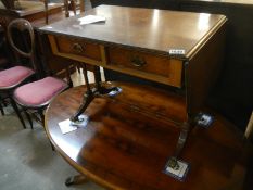An inlaid Sutherland table with 2 drawers and brass lions paw feet