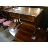 An inlaid Sutherland table with 2 drawers and brass lions paw feet