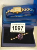 An art deco ladies wristwatch (in working order) and an amethyst stone brooch set in 9ct gold