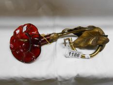 A 19th century brass and ruby glass curtain pole holder with impressed registration mark taken from