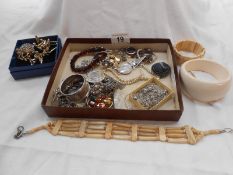 A box of assorted vintage jewellery including silver items