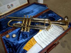 A brass trumpet marked B & M Champion with case