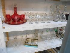 A quantity of Babycham glasses, decanter, ruby glass coloured drinks set,