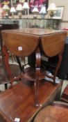 An Edwardian mahogany drop leaf side table with 4 leaf's