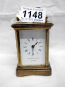 A small brass carriage clock by Matthew Norman,