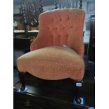 An Edwardian peach covered nursing chair with buttoned back and Queen Anne legs